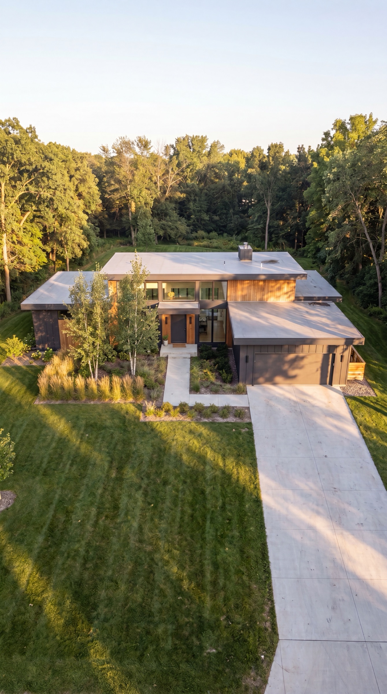 Vertical aerial of a modern home framed by the driveway